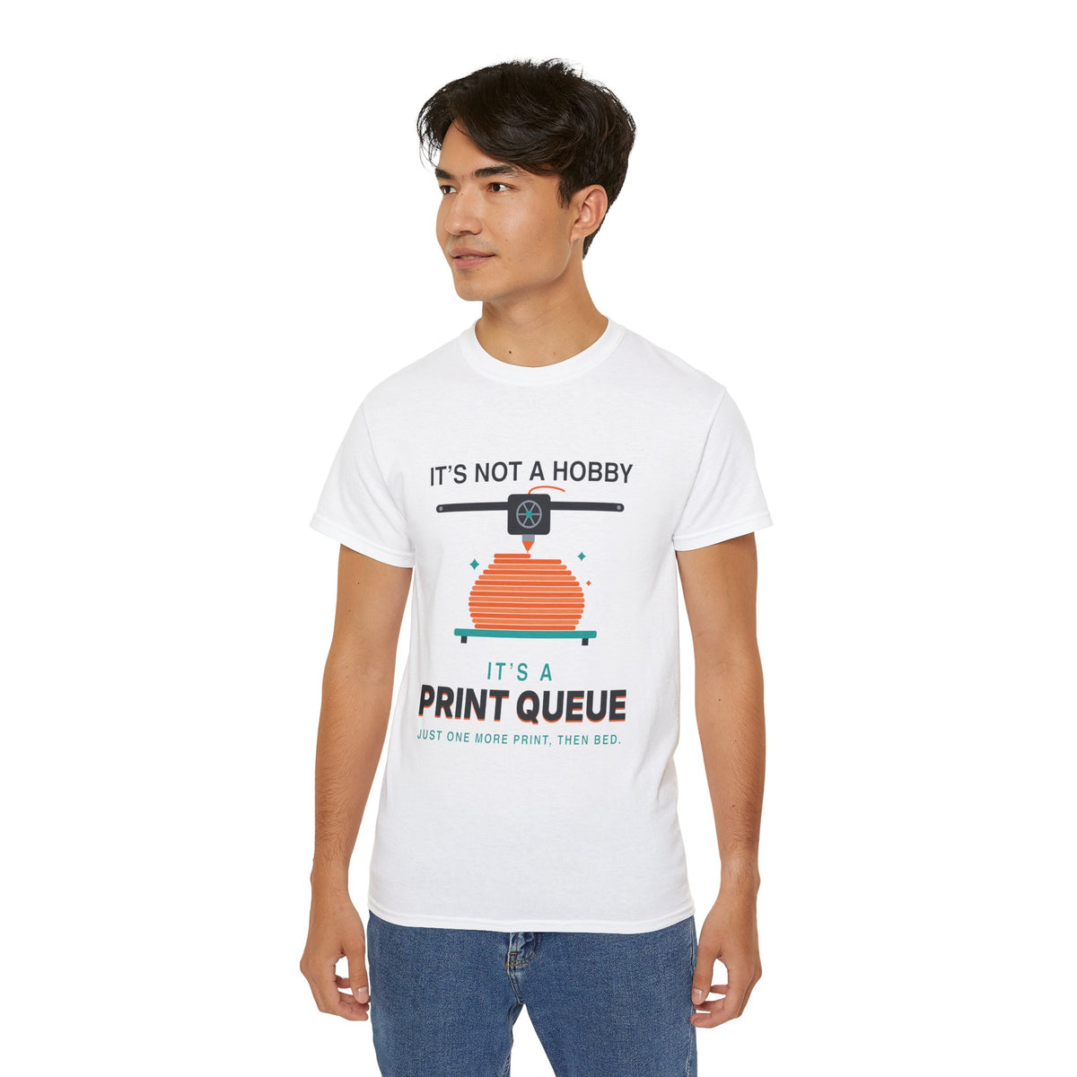 It's a Print Queue 3D printing graphic t-shirt by TeePara, folded and worn by a model